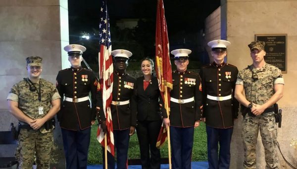 Hannah Fowler posing with members of the U.S. Armed Forces in uniform at the U.S. Embassy in Yaounde, Cameroon