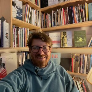 Collin Rice surrounded by books