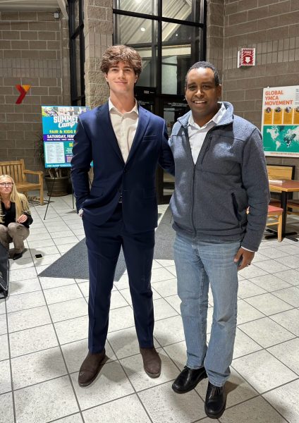 Lancey poses with Congressman Neguse