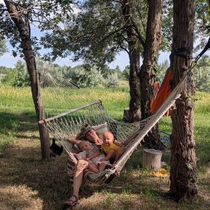 Cheri Noblitt in a hammock with her daughers